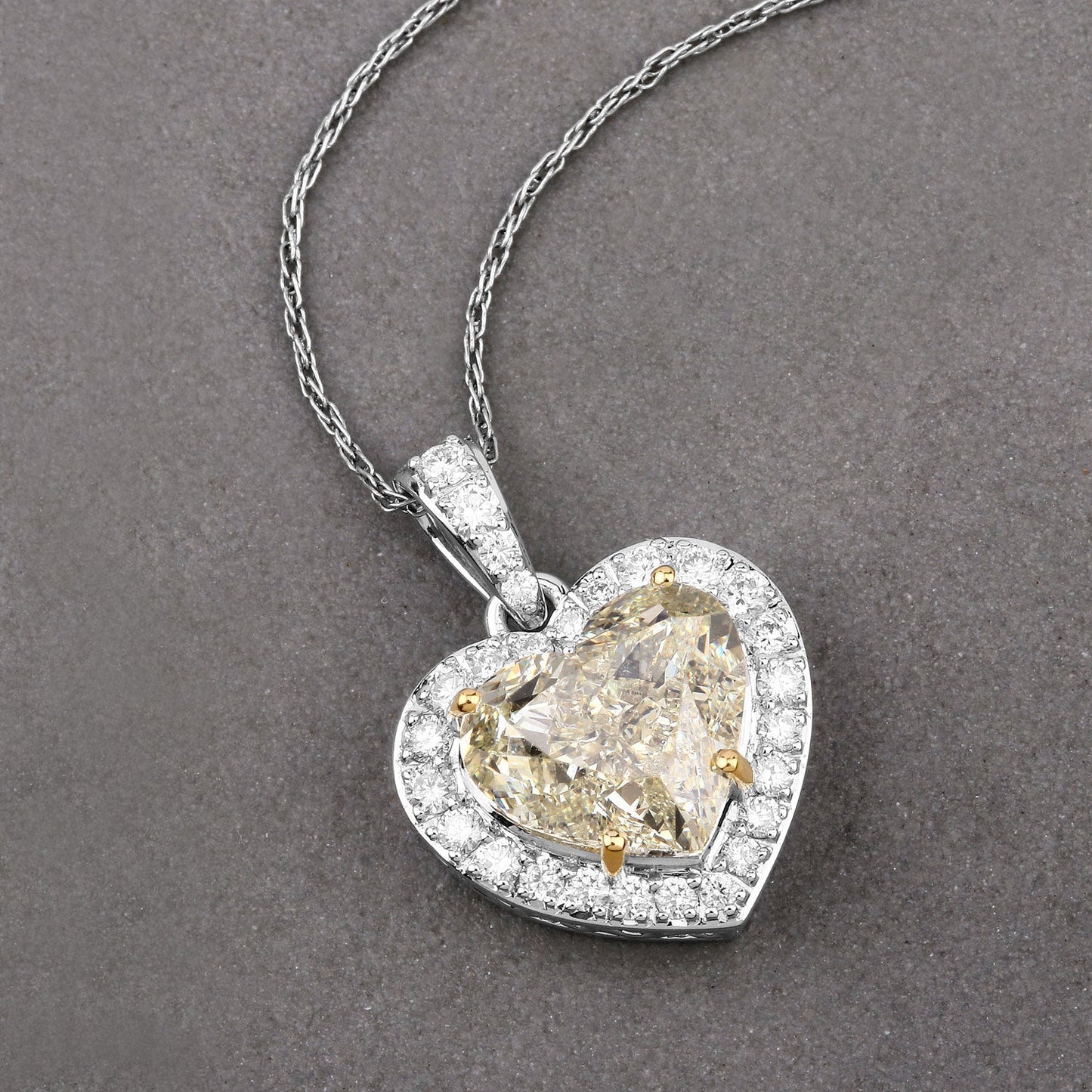 IGI Certified 4.51 Carat Genuine Light Yellow Diamond Center and 0.45cttw White Diamond 18K White Gold Pendant (4.96cttw) Bids.com